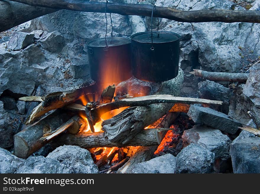 Two touristic caldron in a fire. Two touristic caldron in a fire