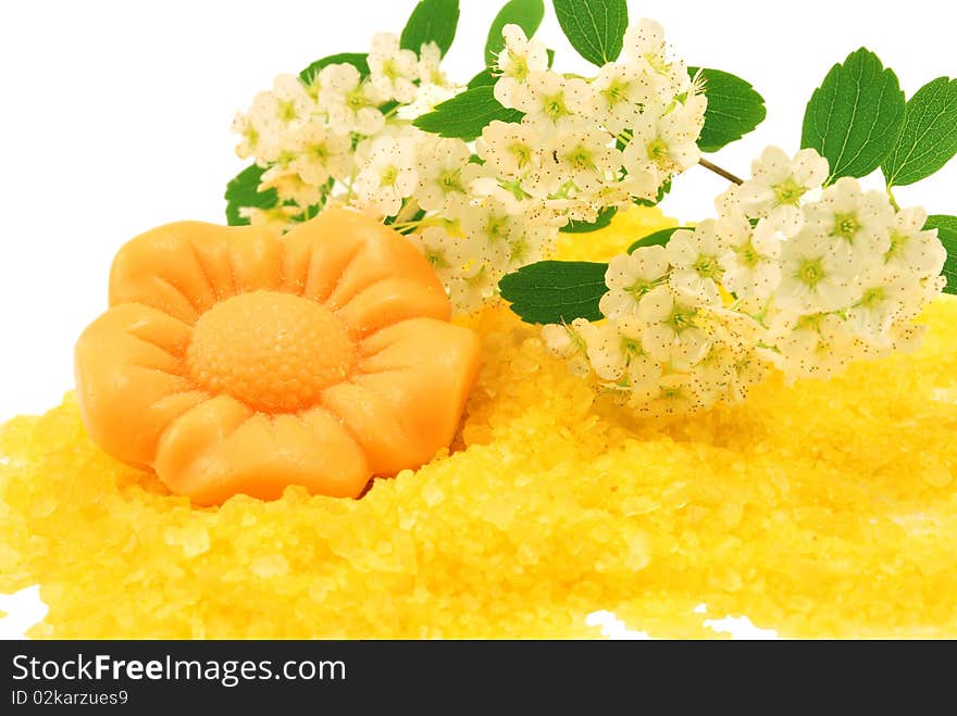 Flower soap over bath salt isolated on white