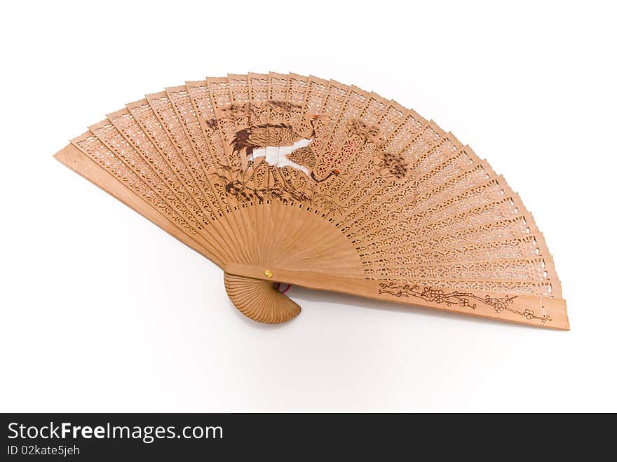 Wooden fan with thread and pattern in Oriental style with a white background. Wooden fan with thread and pattern in Oriental style with a white background