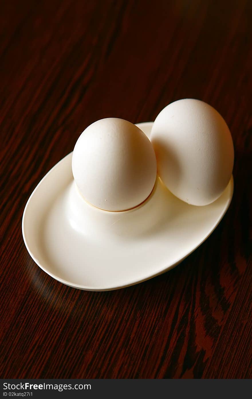 Close-up breakfast with two boiled eggs in white eggcup. Close-up breakfast with two boiled eggs in white eggcup