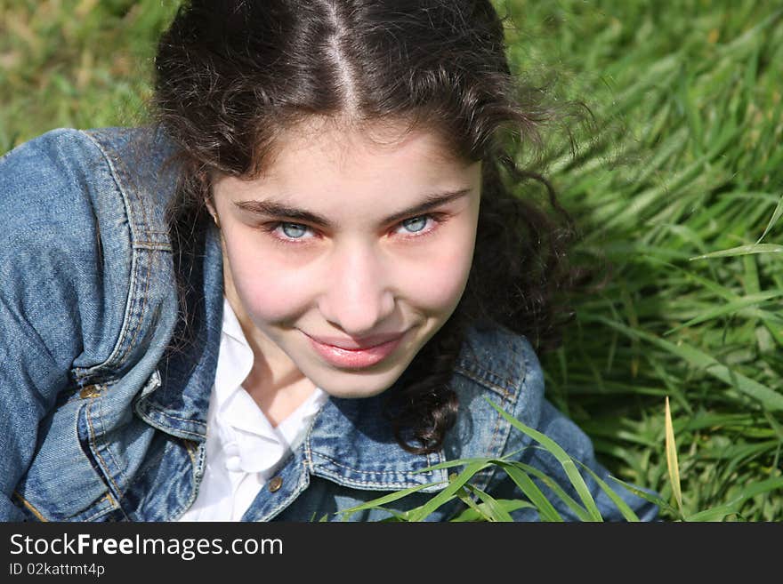 Smiling young  girl on the grass  background