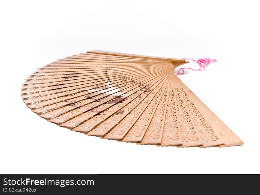 Wooden fan with thread and pattern in Oriental style with a white background. Wooden fan with thread and pattern in Oriental style with a white background