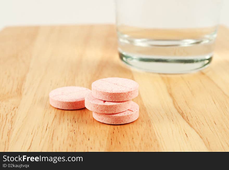 Pink tablets and glass on the table