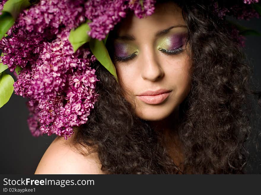 Girl in lilac garland eyes shut