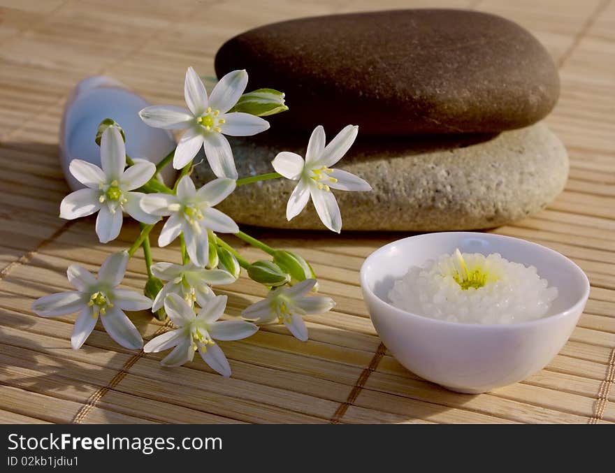 Spa composition of stones , flowers and candle