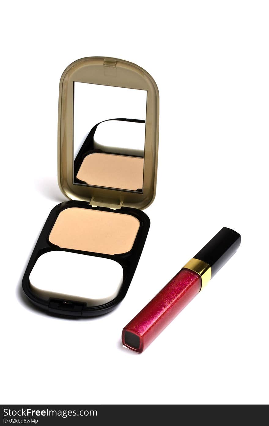 Powder compact and Lip gloss isolated on white