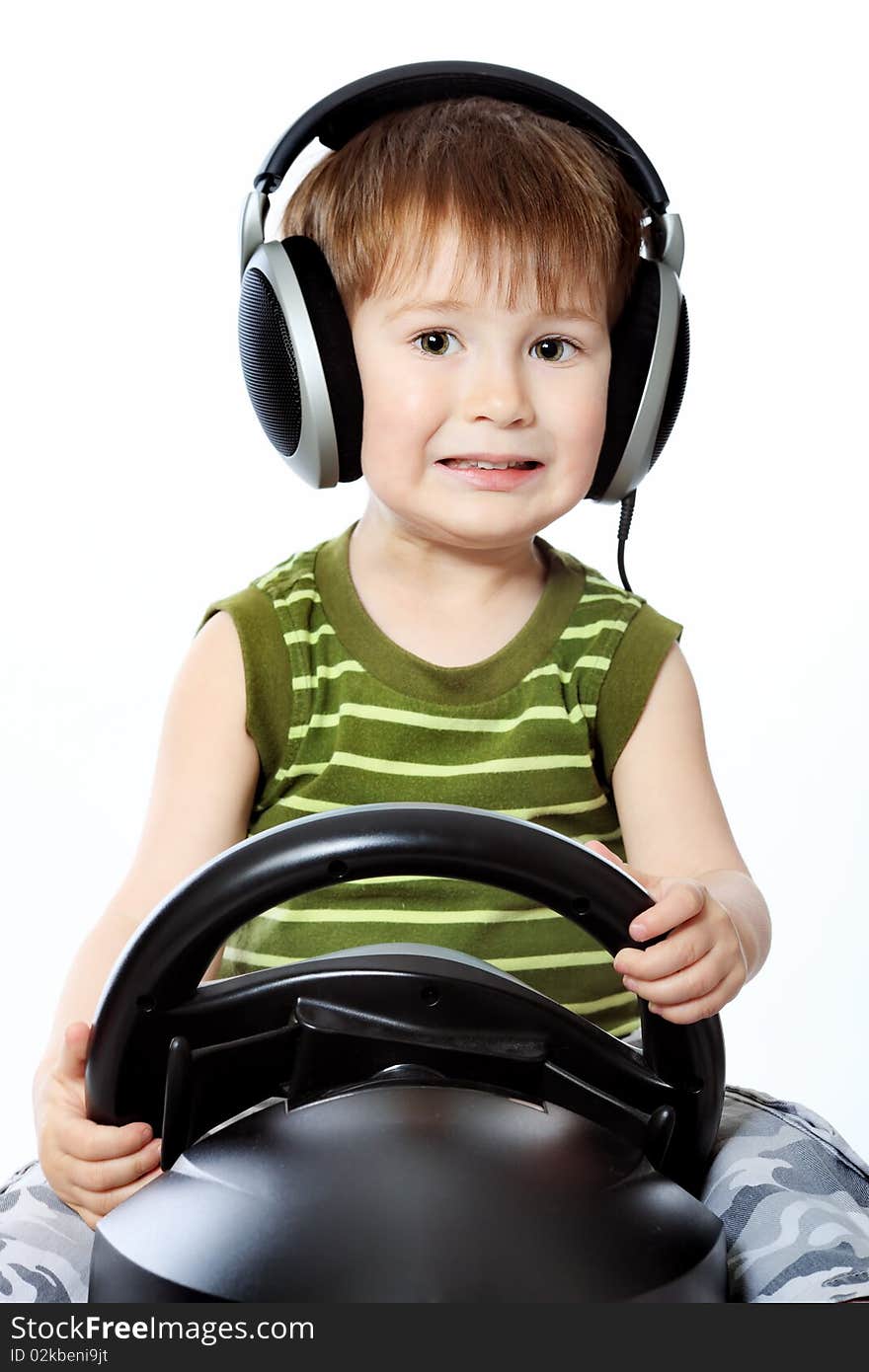 Portrait of a little boy in headphones playing with television-game device. Isolated over white background. Portrait of a little boy in headphones playing with television-game device. Isolated over white background.