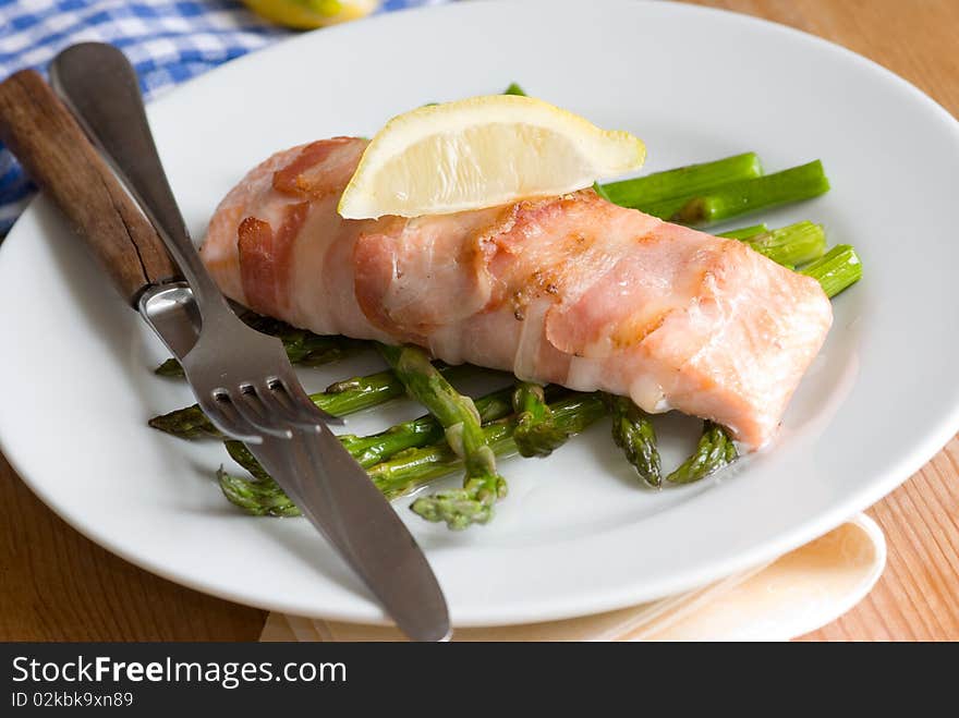 Grilled salmon wrapped in pancetta with asparagus. Grilled salmon wrapped in pancetta with asparagus