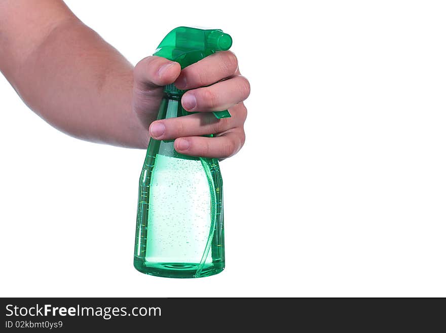 The man's hand holds a spray for water dispersion.