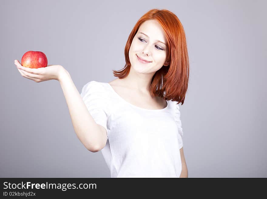 Girl with red apple in hand.