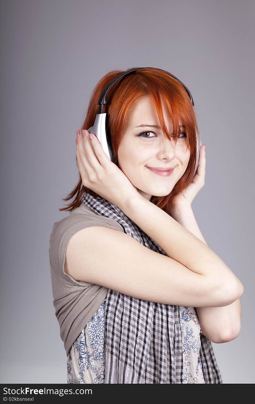 Girl with modern headphones. Studio shot.