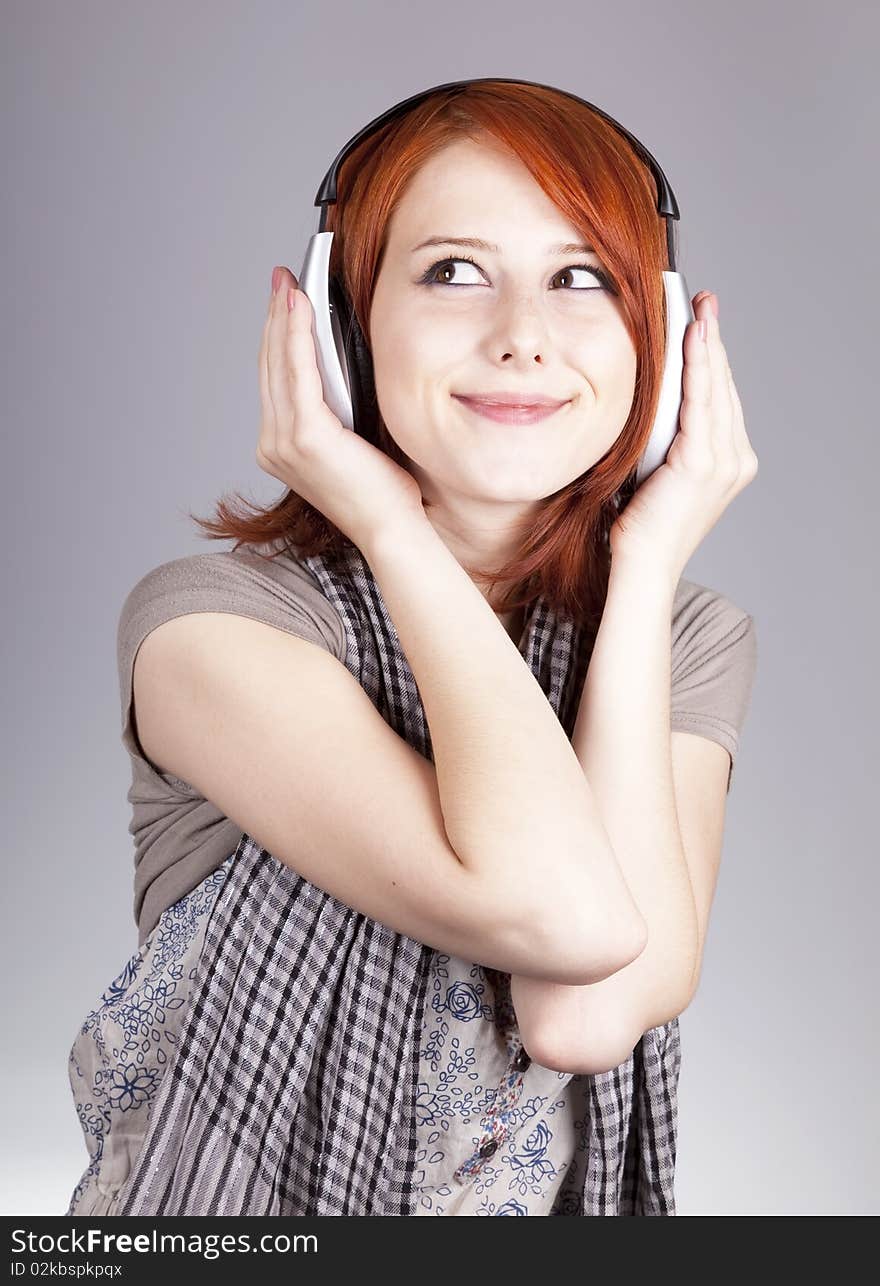 Girl with modern headphones. Studio shot.