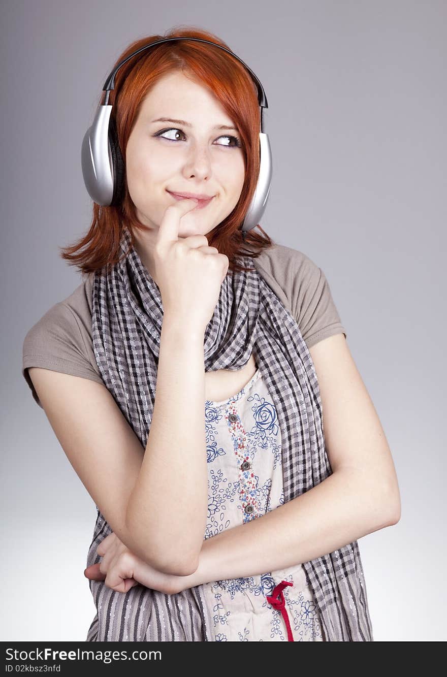 Girl with modern headphones. Studio shot.