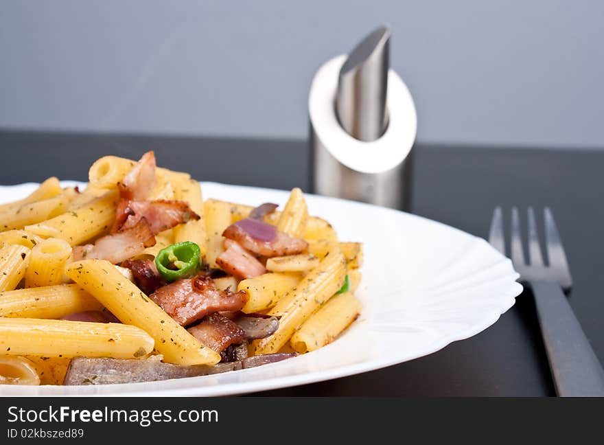 Penne with fried bacon garlic and onion