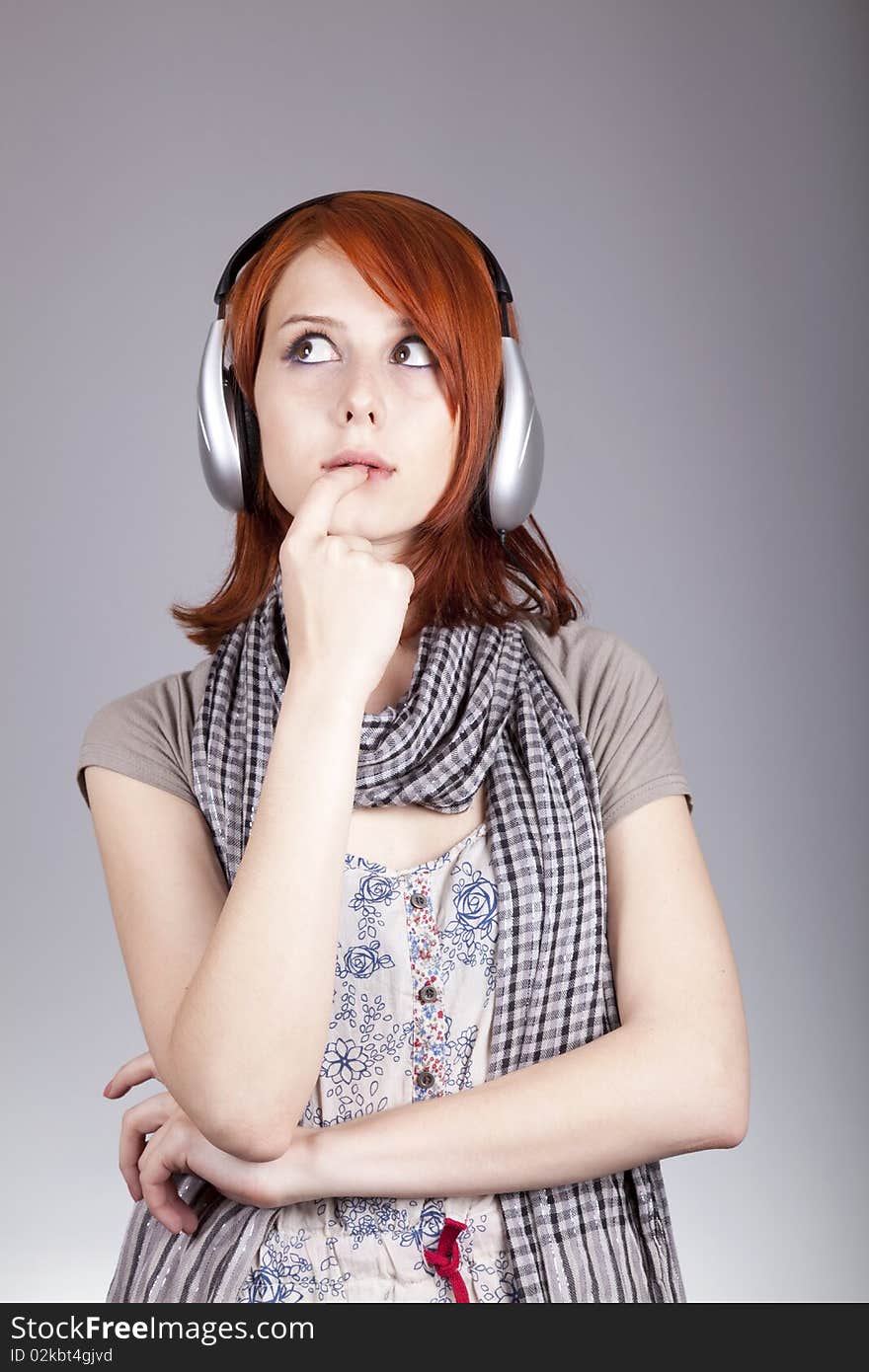 Girl with modern headphones. Studio shot.