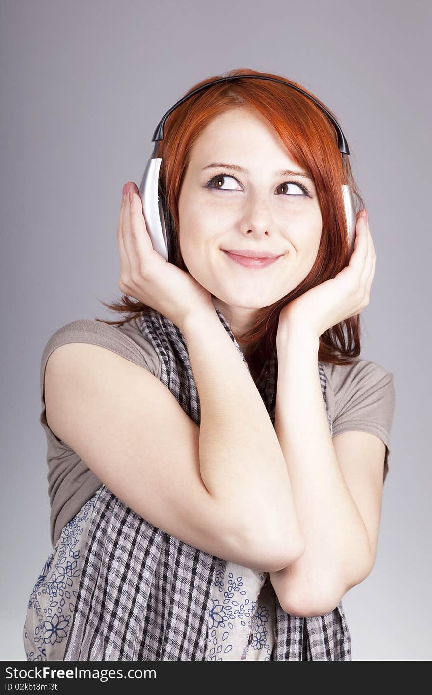 Girl with modern headphones. Studio shot.