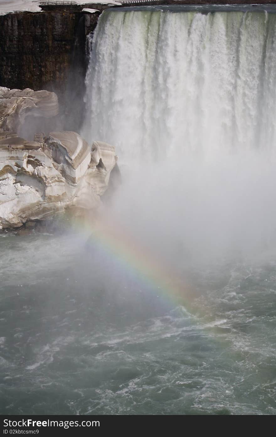 Rainbow over the waterfall and ice block. Rainbow over the waterfall and ice block