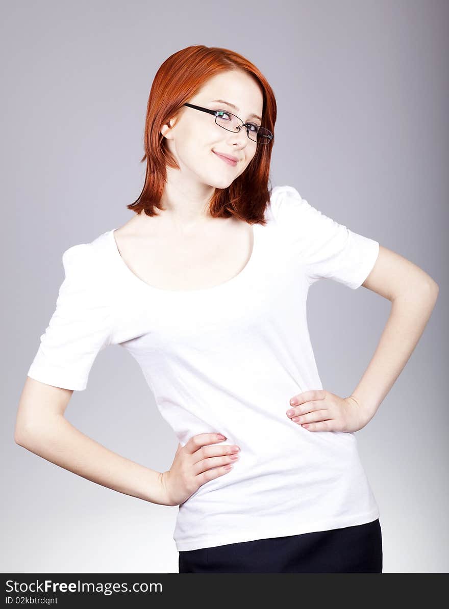 Smiling red-haired businesswoman in sunglasses.