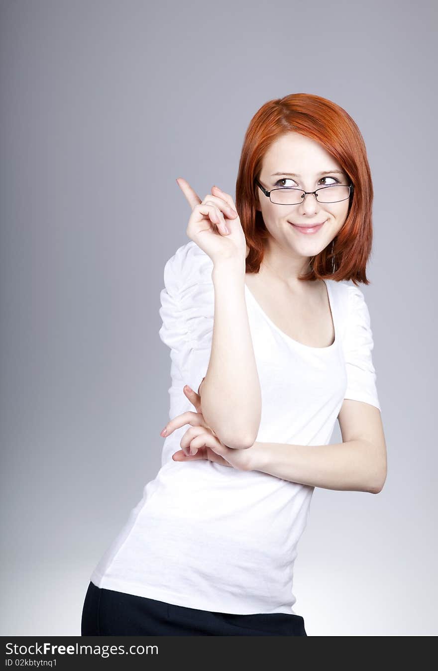 Smiling red-haired businesswoman in sunglasses