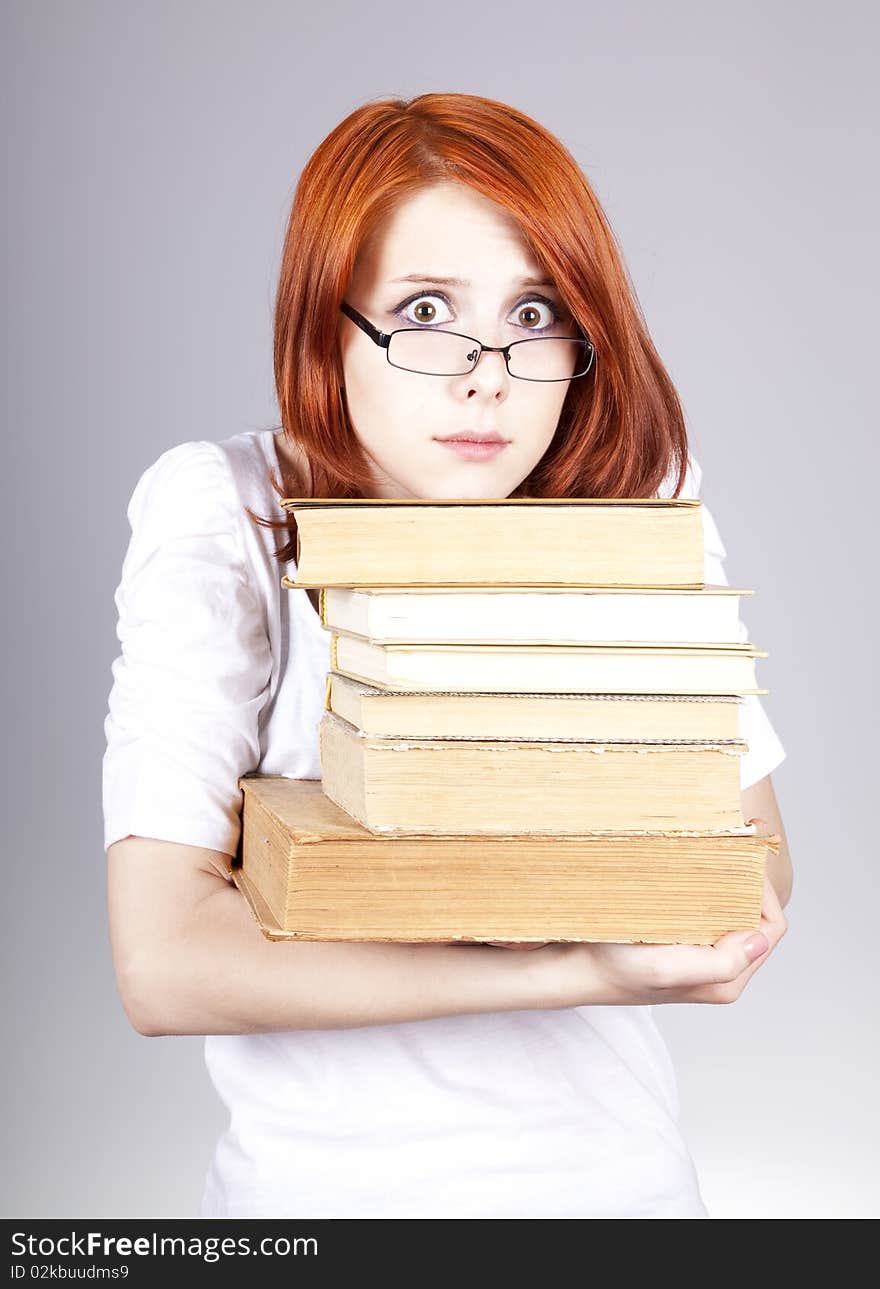 Red-haired smiling businesswoman keep books in hand. Red-haired smiling businesswoman keep books in hand.