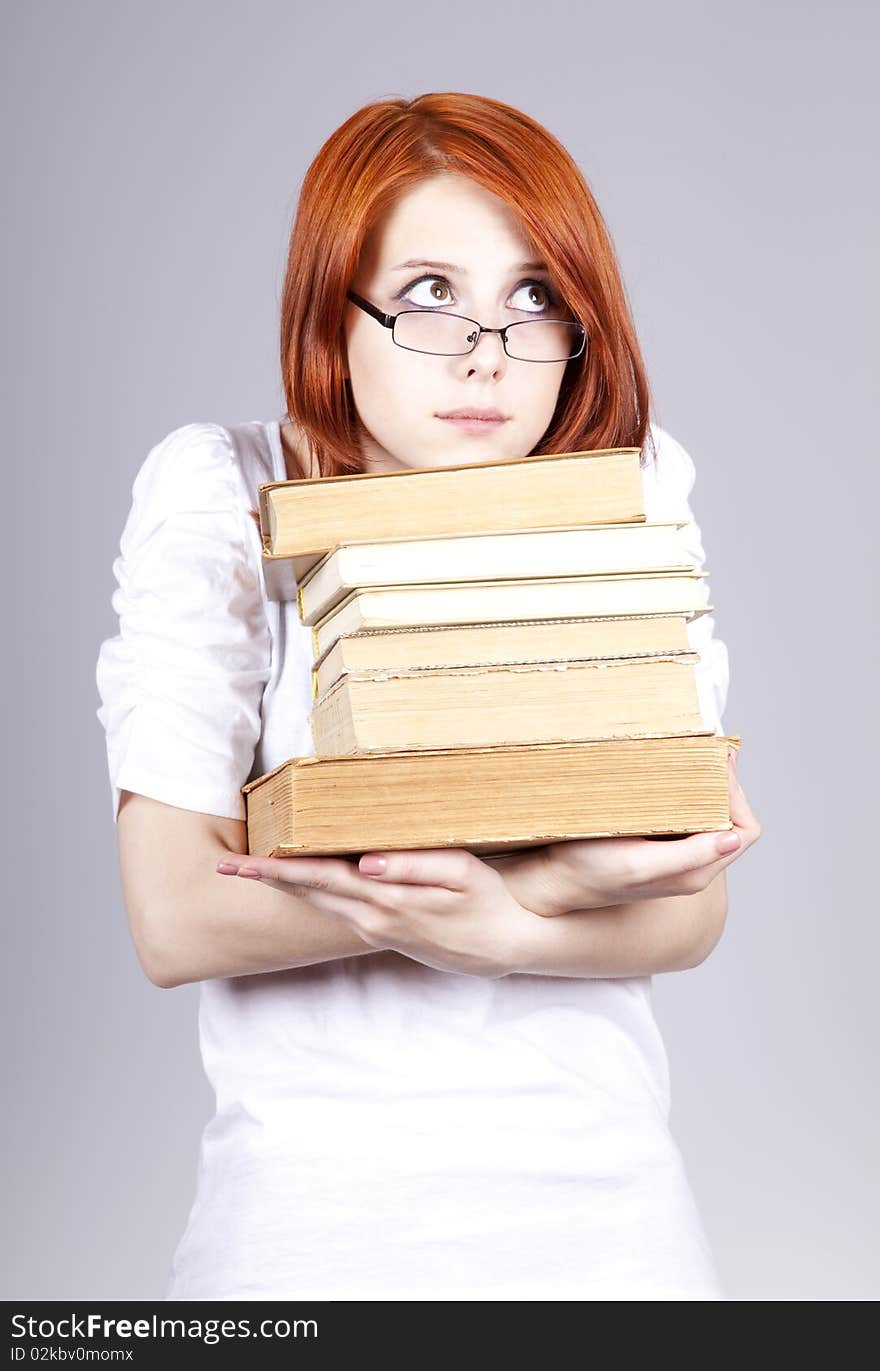 Red-haired businesswoman keep books in hand.