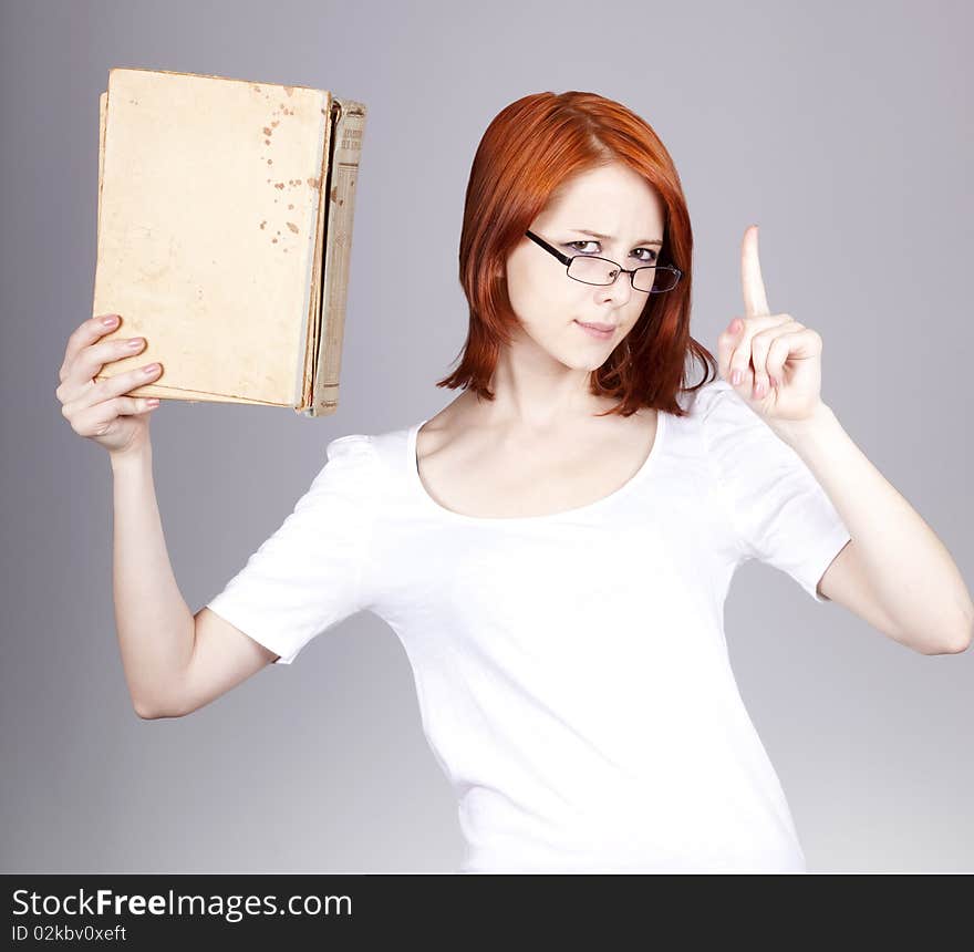 Red-haired businesswoman  keep books in hand.