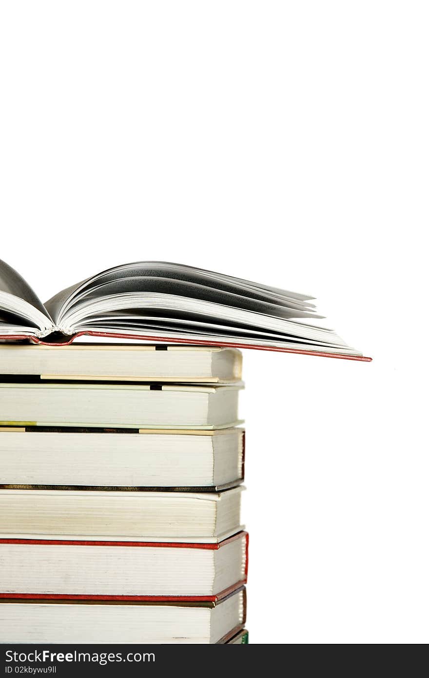 Open book resting on stack of books