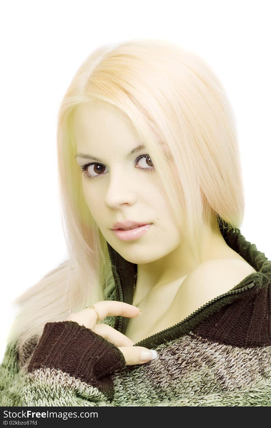 Young blonde woman in sweater with make-up on white background