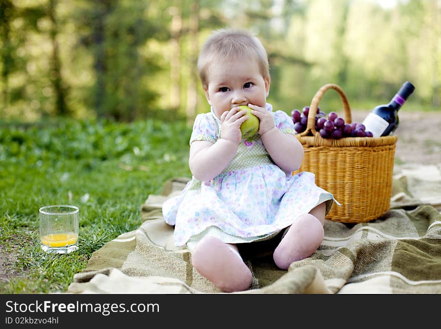 Baby girl eating green apple in the nature. Baby girl eating green apple in the nature