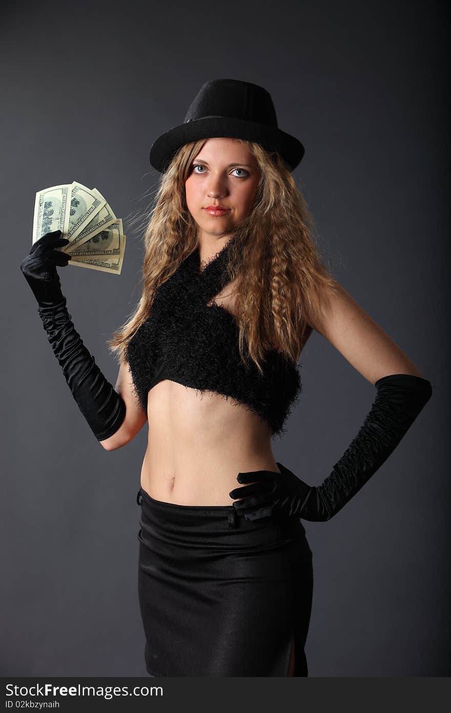 Girl in a hat holding a dollars