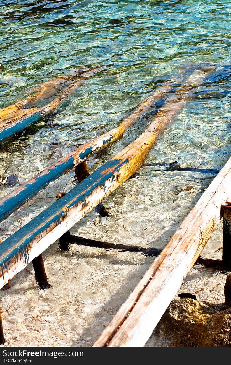 Wooden poles for boats on the sea. Wooden poles for boats on the sea