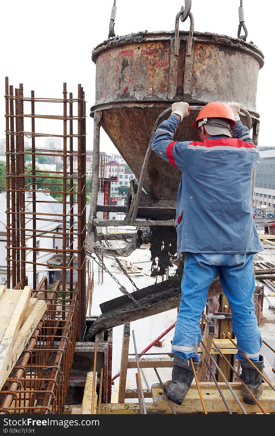 Construction building worker at construction site pouring concrete in form. Construction building worker at construction site pouring concrete in form