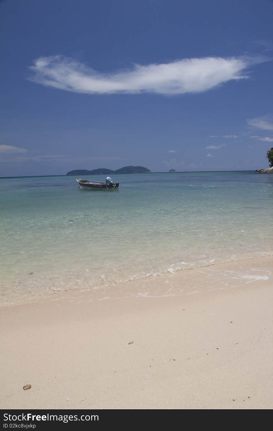 Beautiful island coastline with white sand, palm trees and baby blue water. Beautiful island coastline with white sand, palm trees and baby blue water