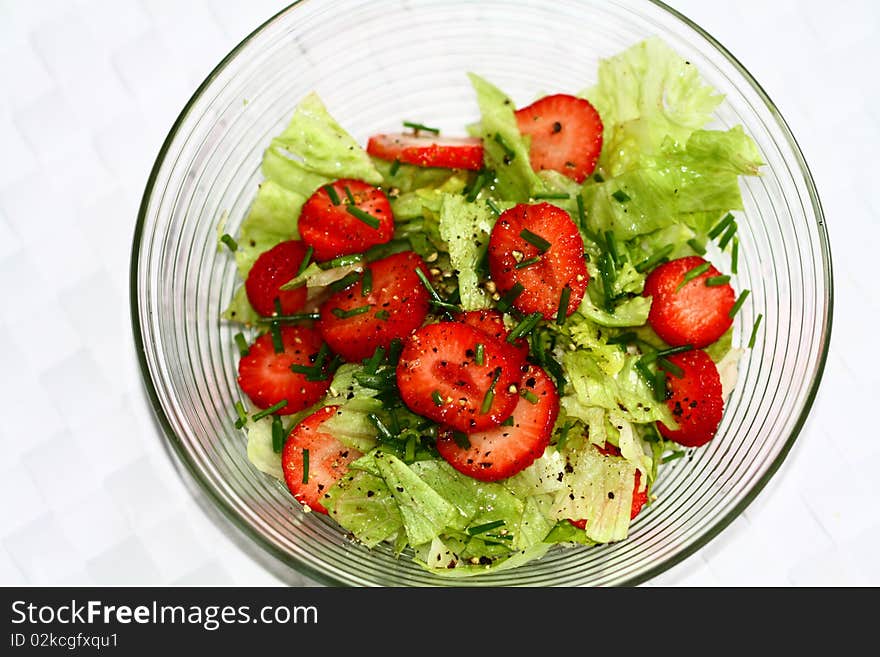 Salad bowl with ice salad, fresh strawberries and chives, pepper. Salad bowl with ice salad, fresh strawberries and chives, pepper.