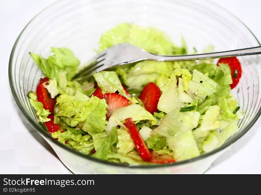 Salad bowl with fresh strawberries, ice salad and chives, pepper. Salad bowl with fresh strawberries, ice salad and chives, pepper.