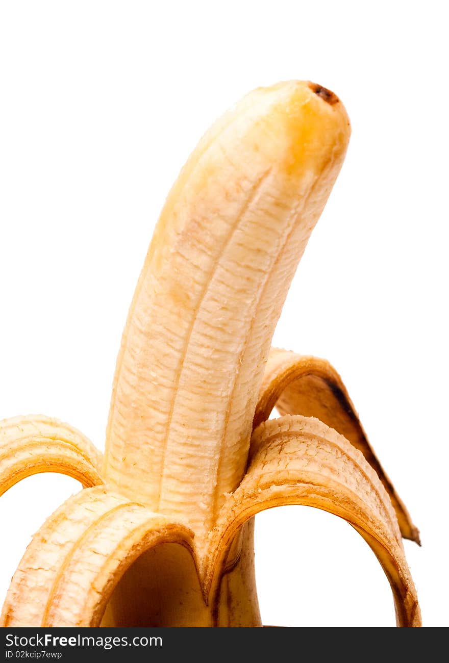 One banana with the removed peel, a close up. It is isolated