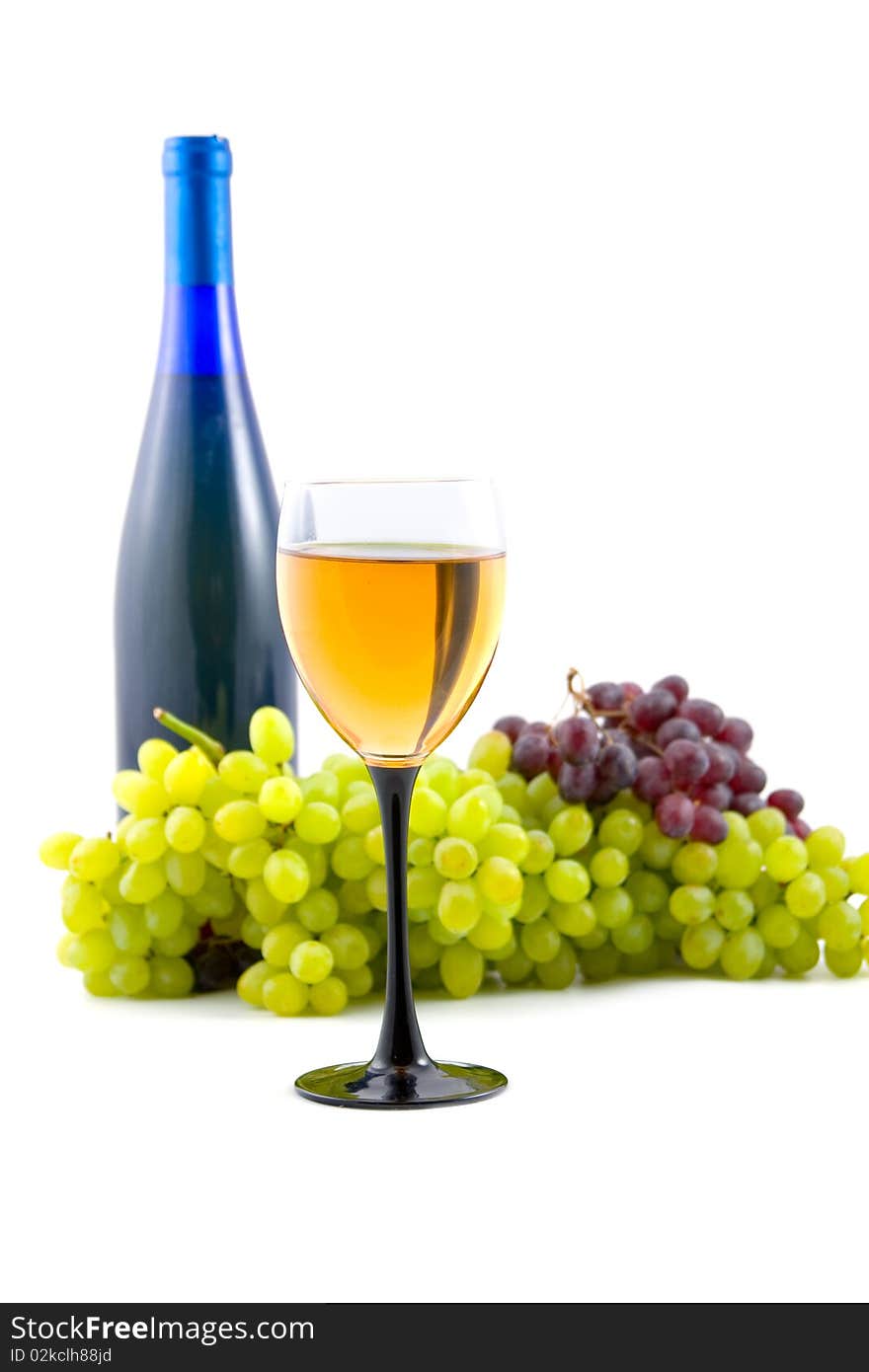 Glass of wine on the background of the bottle and grapes