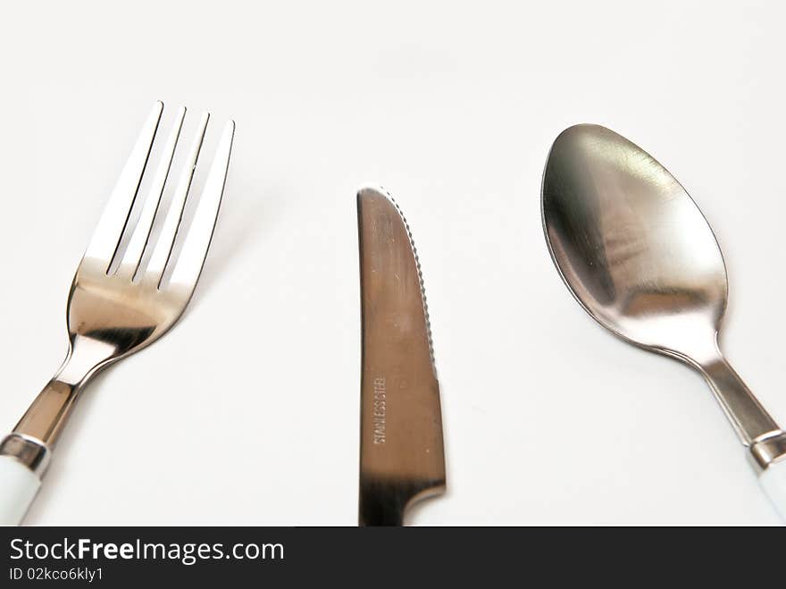 Knife fork spoon in the table. Grey background