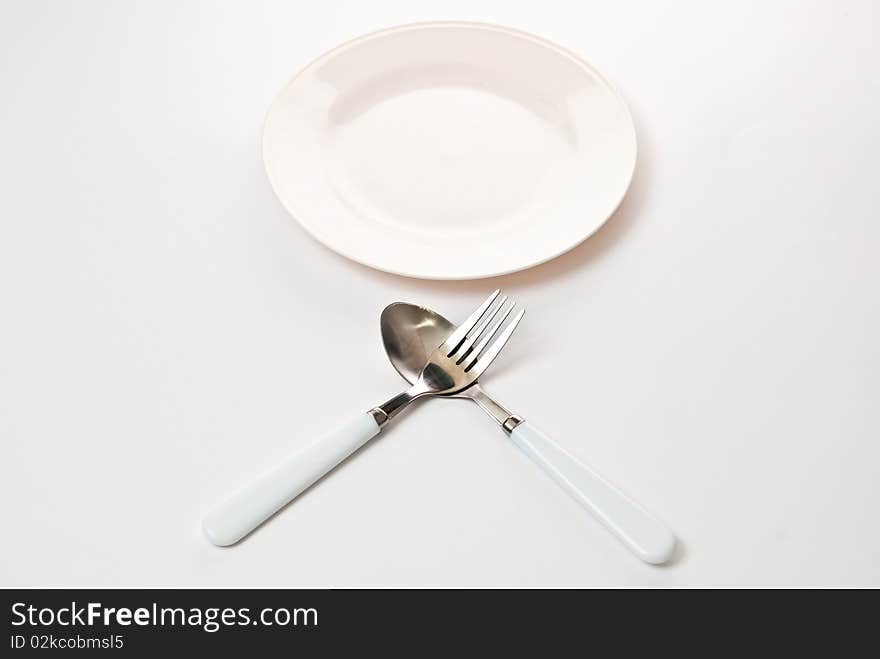 Set of kitchen object. The spoon, a fork separately on a grey background. Set of kitchen object. The spoon, a fork separately on a grey background.