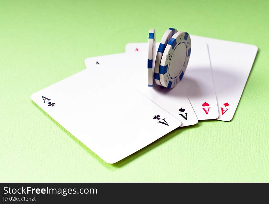 Cards and chips for poker night, four of a kind raising