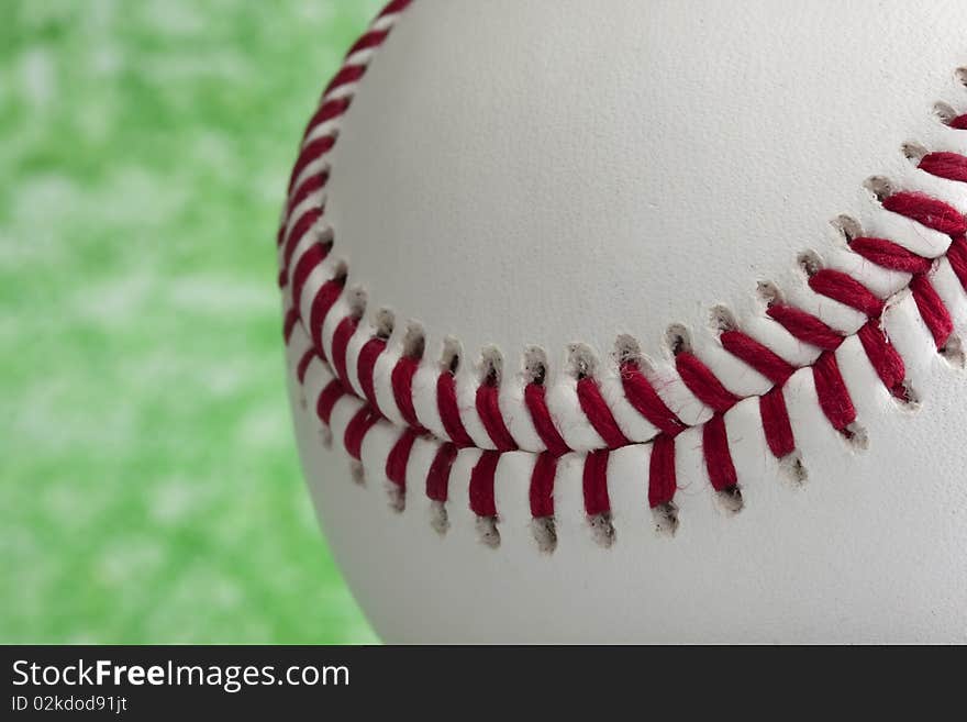 Close up on a baseball on the ground. Close up on a baseball on the ground.