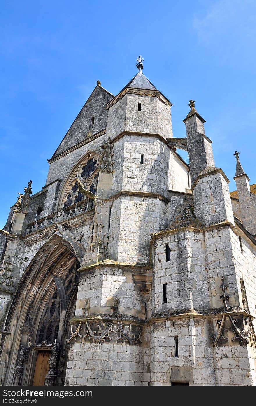 A big european gothic church in front a blue sky