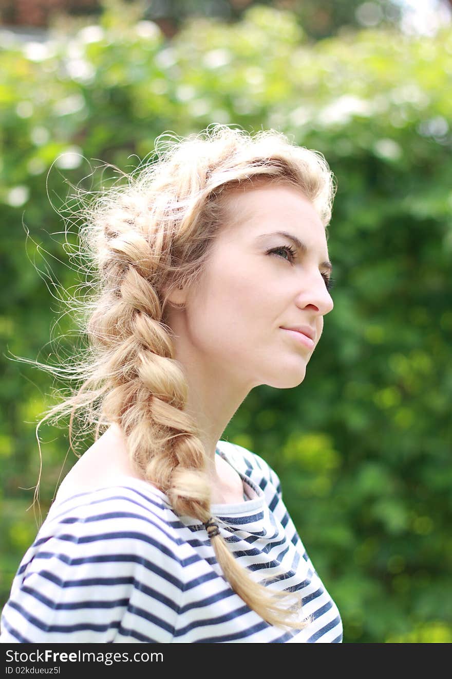 Young attractive blond girl in the garden. Young attractive blond girl in the garden