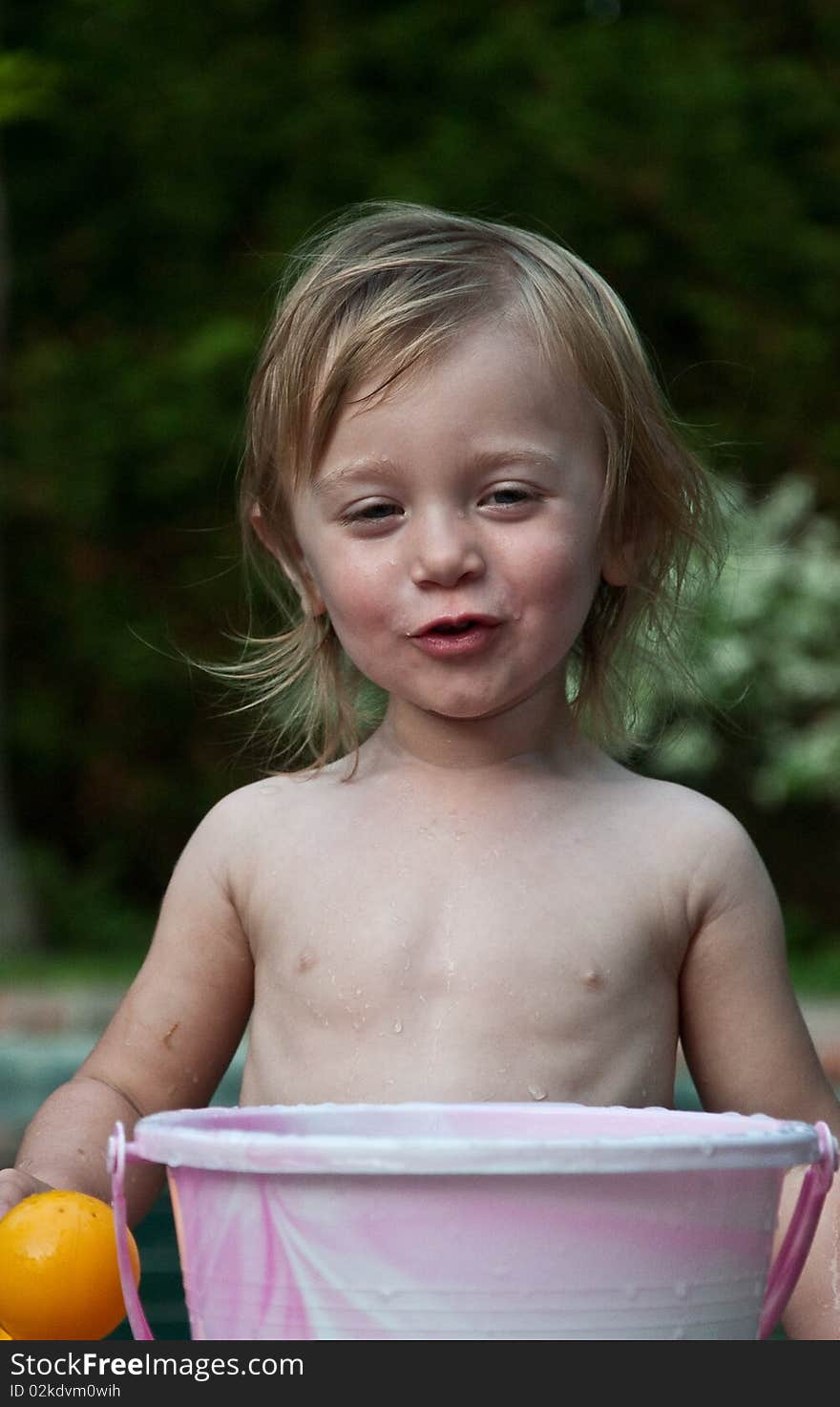 Little Girl Smiling with Bucket by Pool. Little Girl Smiling with Bucket by Pool