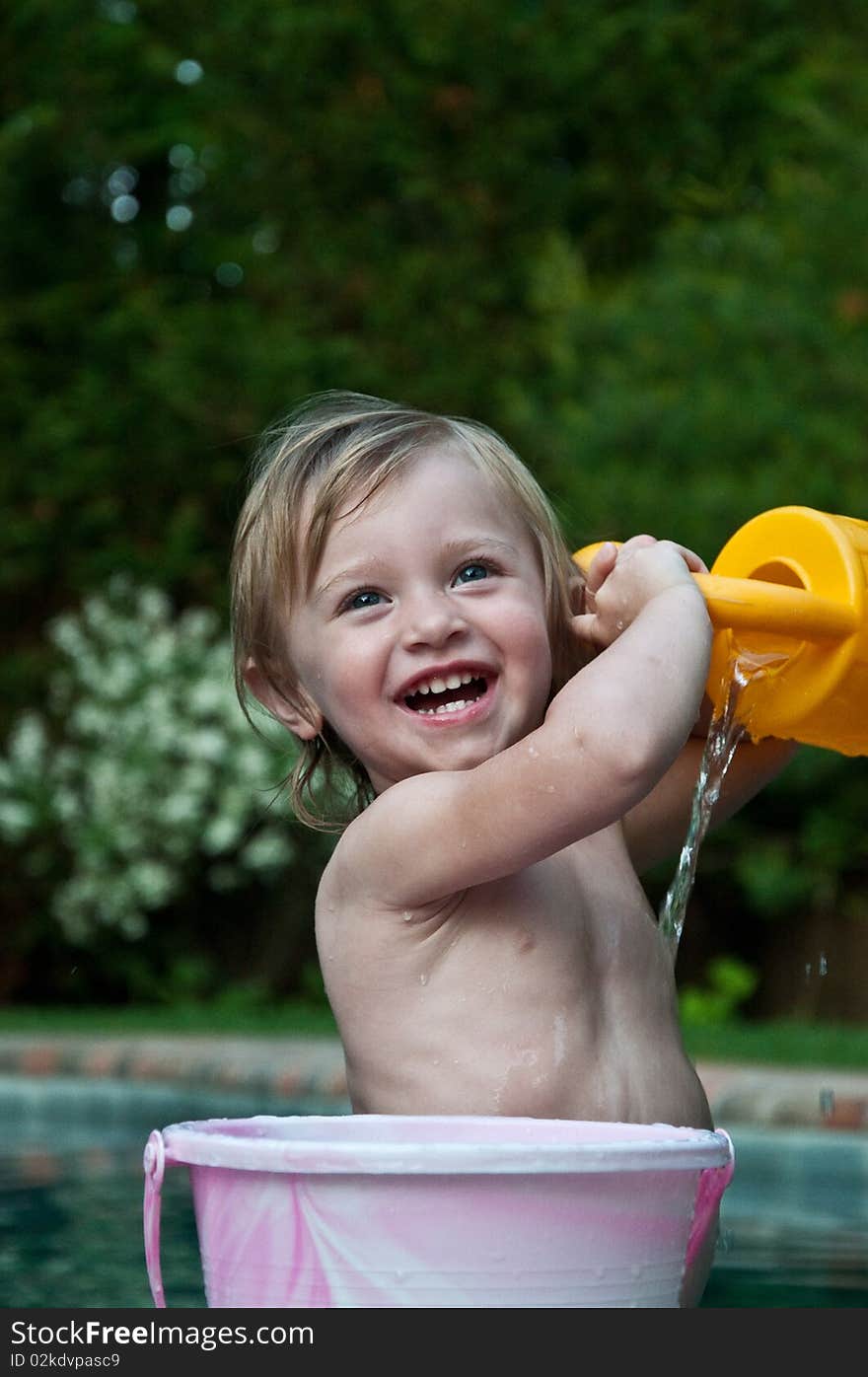 Little Girl Showering with Bucket by Pool. Little Girl Showering with Bucket by Pool