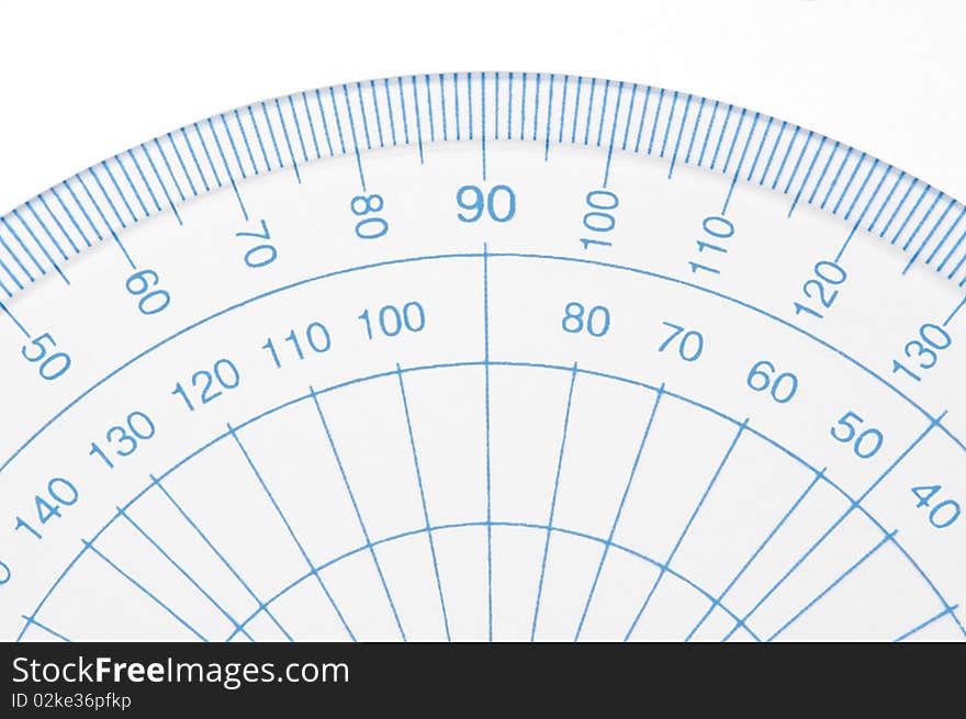 Close Up capturing a portion of a transparent plastic protractor arranged over white. Close Up capturing a portion of a transparent plastic protractor arranged over white.