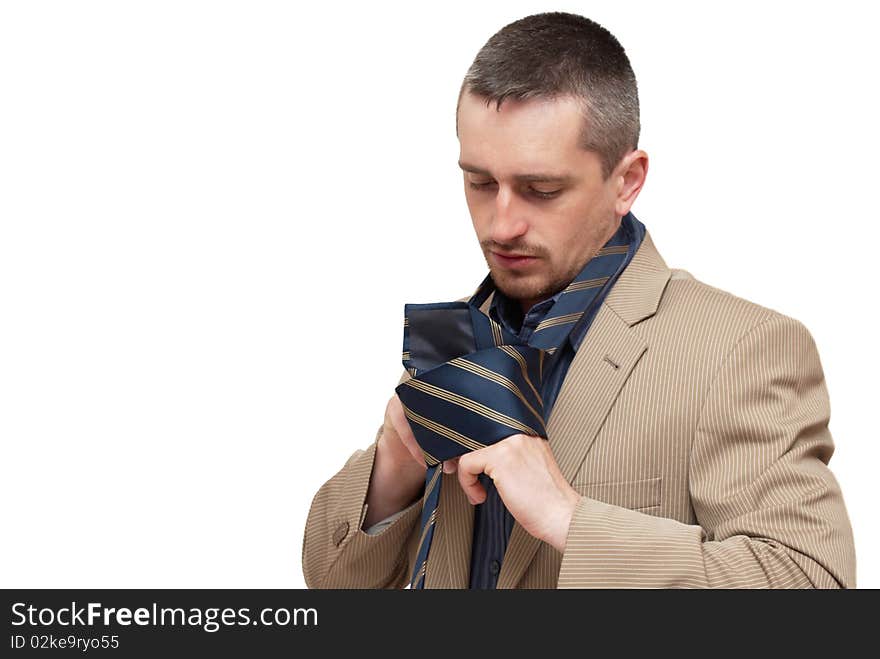 The man fastening a tie on a white background