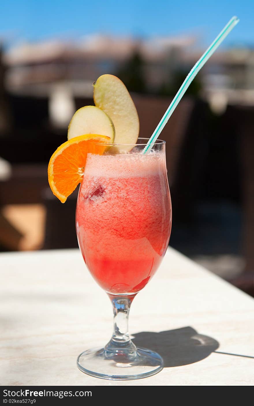 A glass of red fruit juice in summer