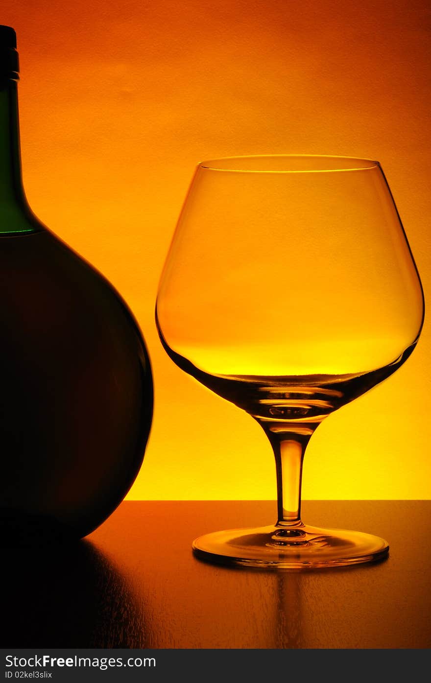 Cognac bottle and empty glass. Cognac bottle and empty glass