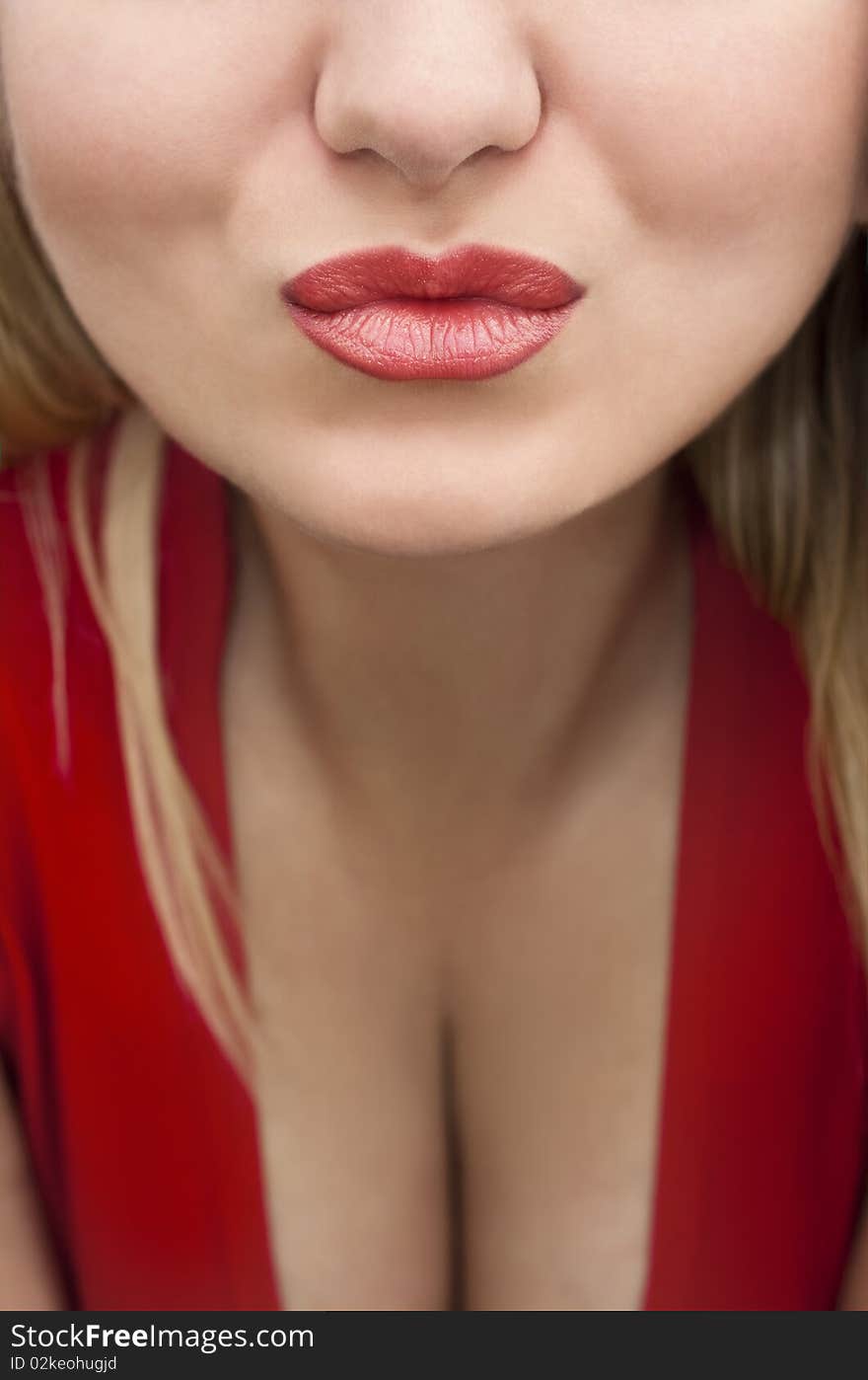 Beautiful blonde girl in a red shirt with a neckline, get ready to kiss. Beautiful blonde girl in a red shirt with a neckline, get ready to kiss